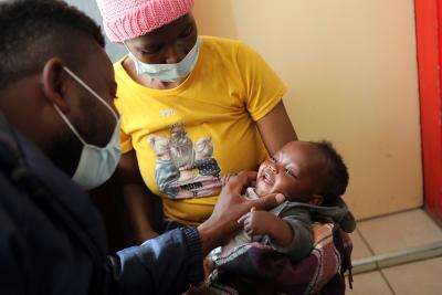 Nurse Mohlomi Maputle conducts a pediatric checkup